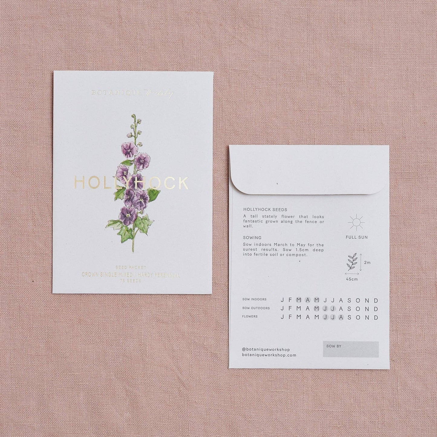Floral product packaging with a card and envelope on a textured surface