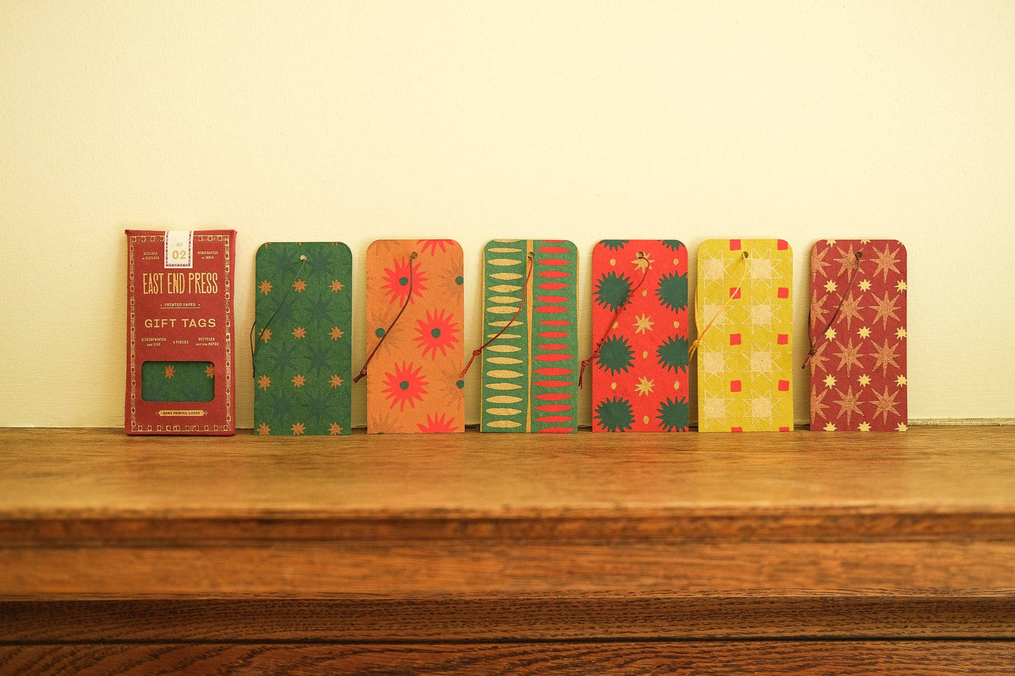 Set of colorful gift tags on a wooden surface with a neutral background