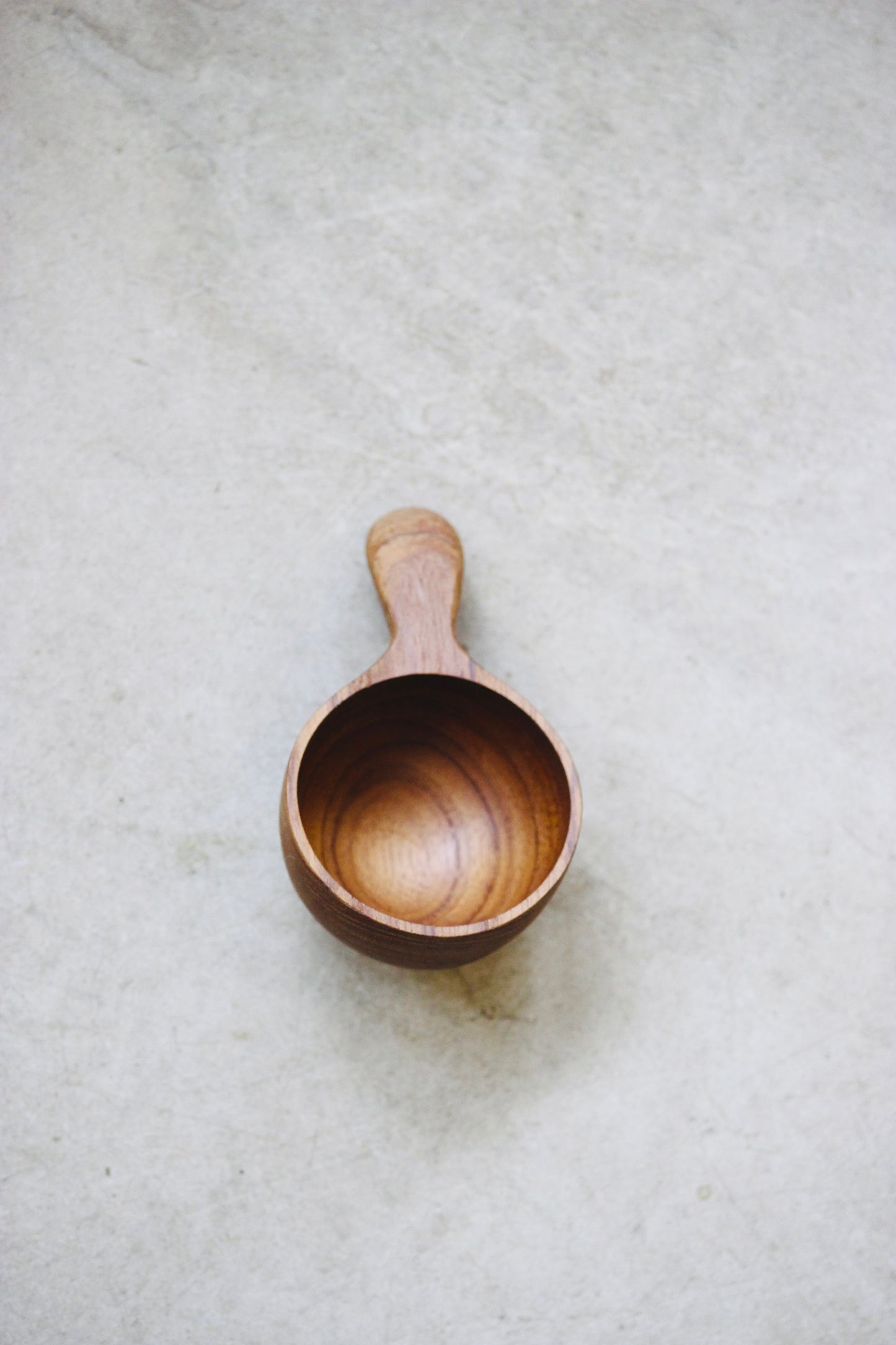 The Amuze Spoon is a versatile tool that can be used to serve appetizers or scoop up coffee and tea. Made from durable and reclaimed teak root wood, each piece boasts a unique, organic design and is food safe.