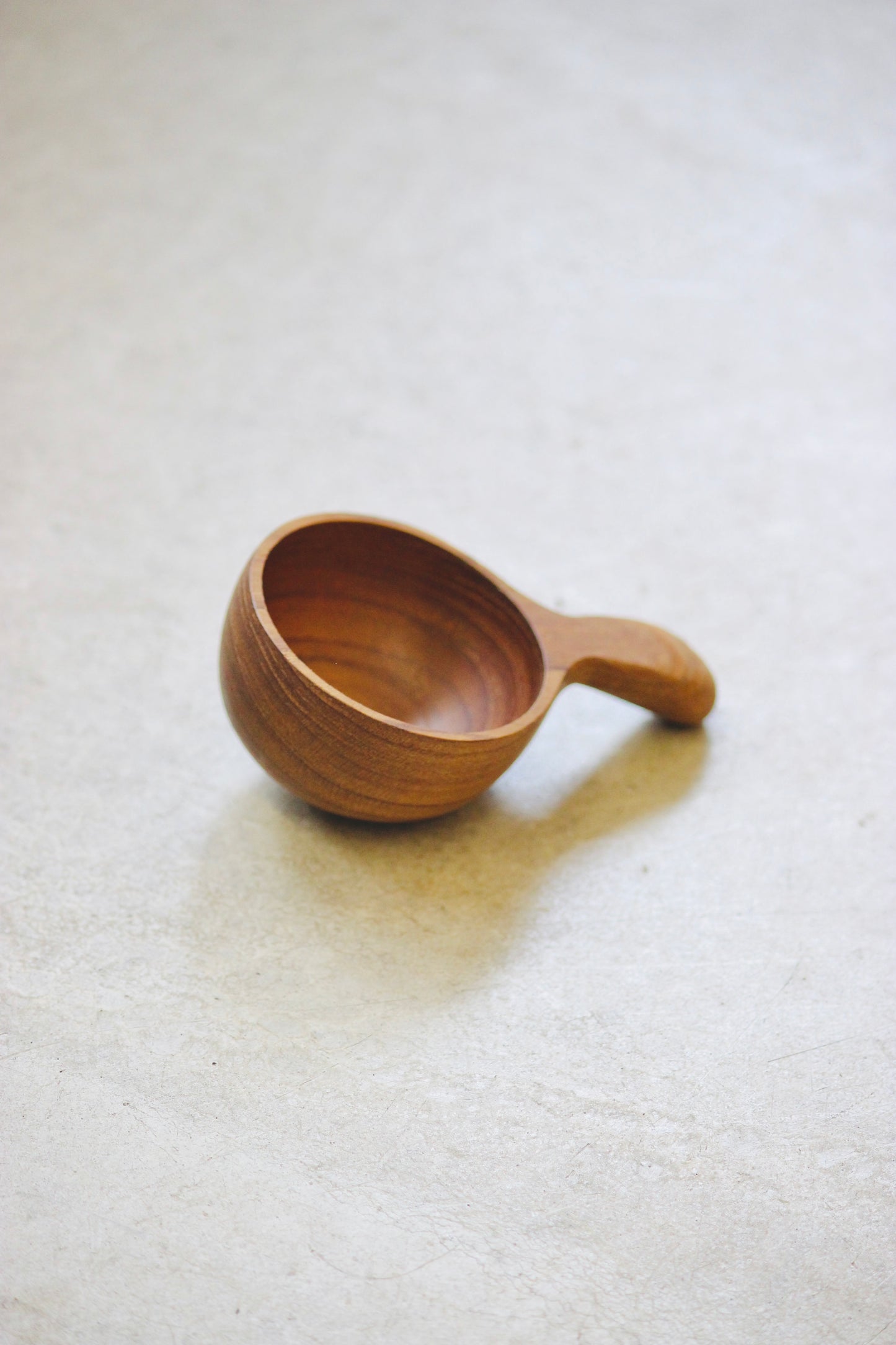 The Amuze Spoon is a versatile tool that can be used to serve appetizers or scoop up coffee and tea. Made from durable and reclaimed teak root wood, each piece boasts a unique, organic design and is food safe.