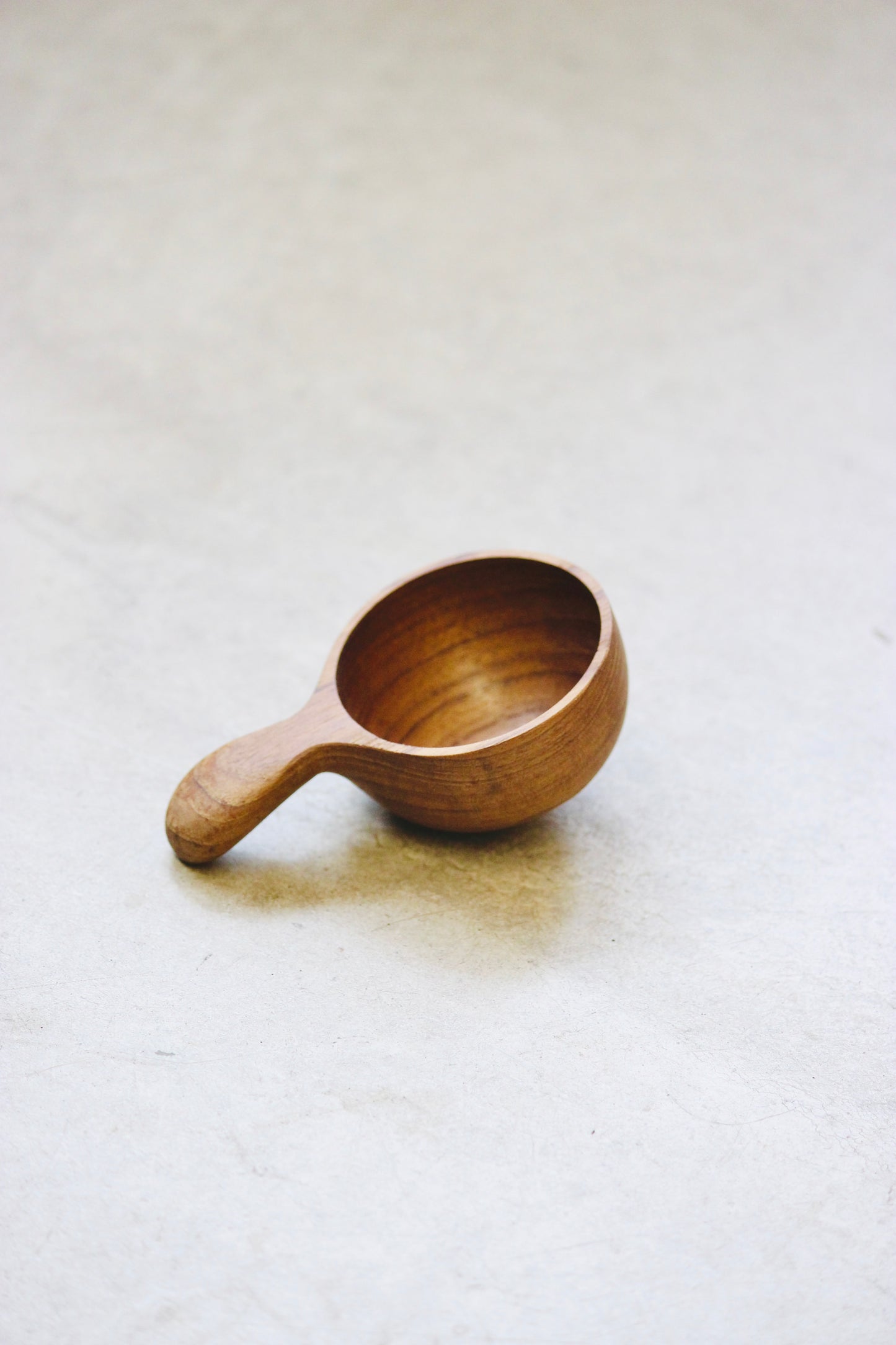 The Amuze Spoon is a versatile tool that can be used to serve appetizers or scoop up coffee and tea. Made from durable and reclaimed teak root wood, each piece boasts a unique, organic design and is food safe.