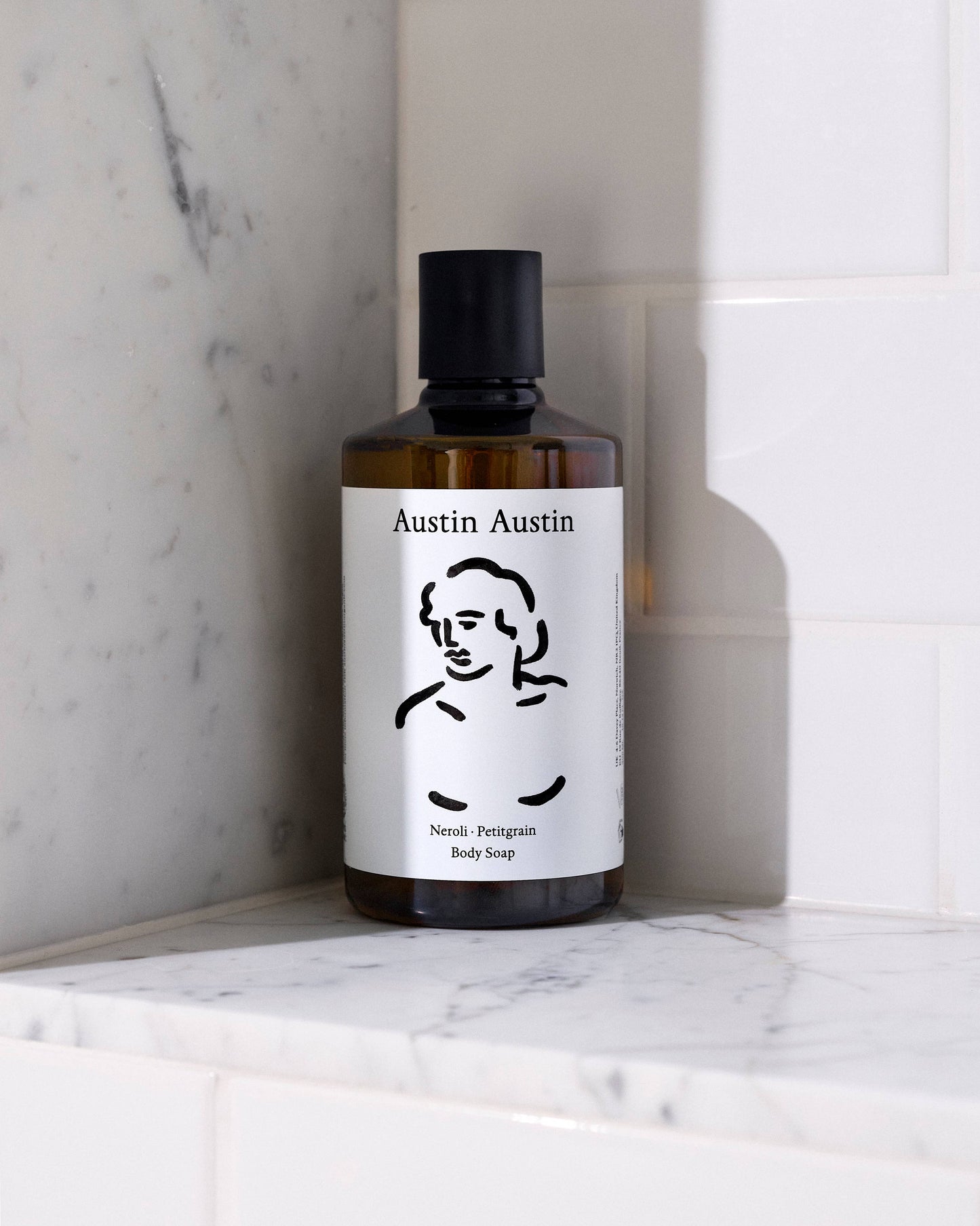 Bottle of Austin Austin body wash on a marble surface