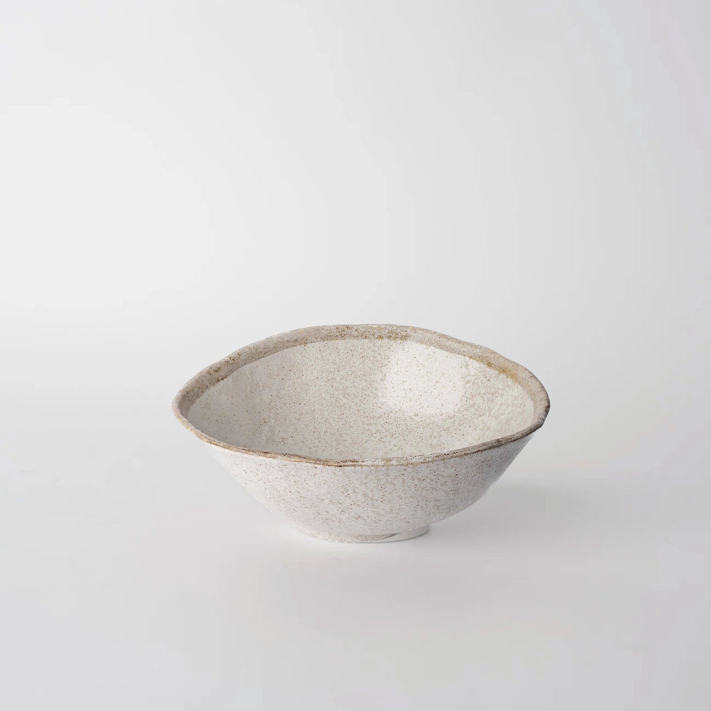 Ceramic bowl with speckled texture on a light gray background
