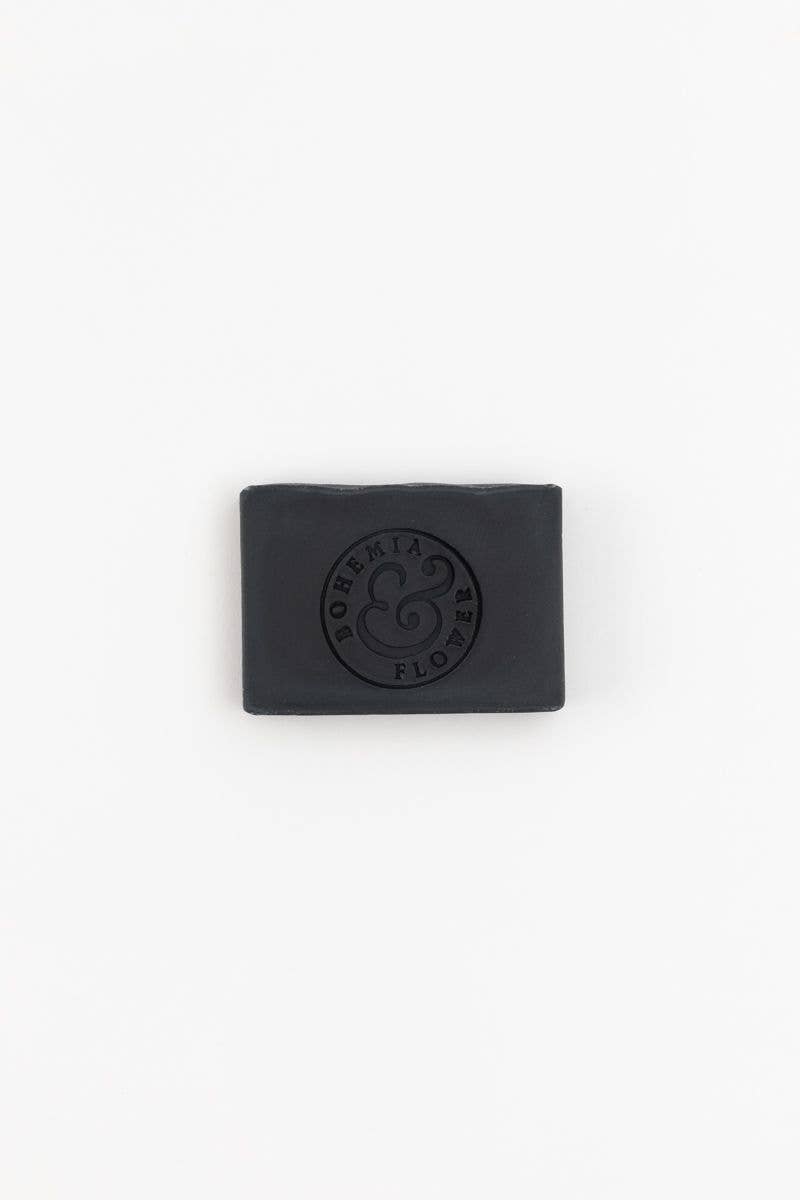 Black soap bar with a logo on a white background