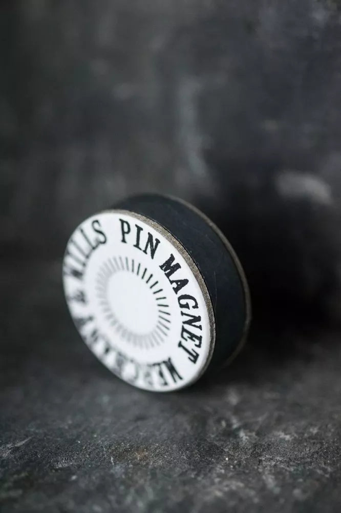 Pin magnet with 'Merchant & Mills Pin Magnet' text on a dark background