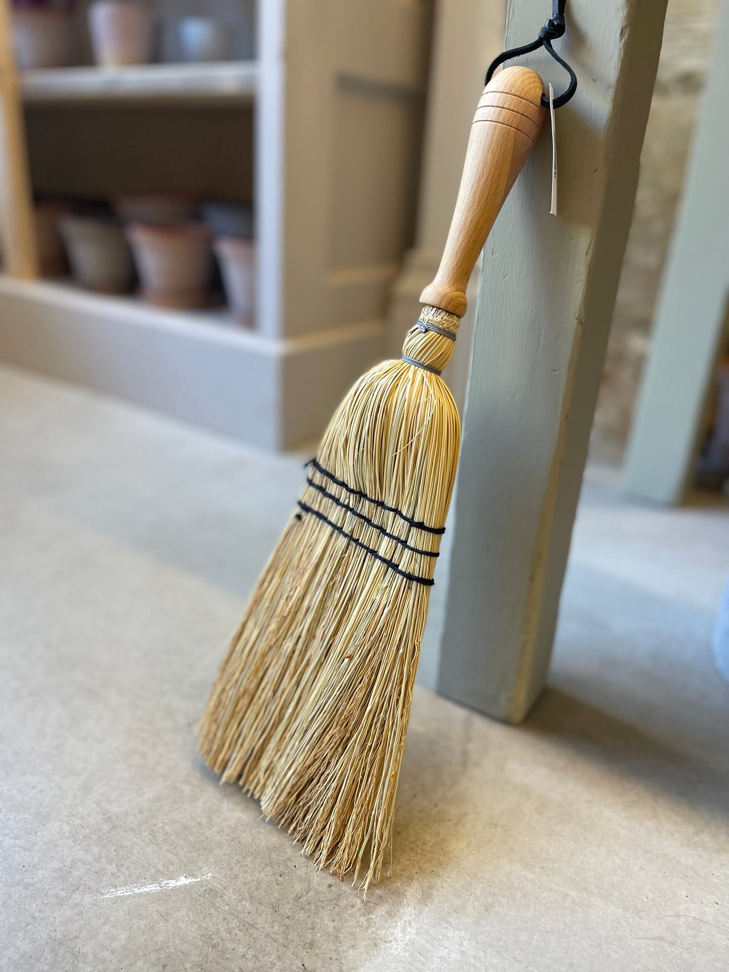 Crafted from oiled beechwood and rice straw, this hand brush is ideal for indoor and outdoor use. Its non-absorbent properties make it perfect for sweeping up car mats and other surfaces. Measuring at 43cm, this is a smaller handheld brush designed in the shape of a broom. Please note that it is not a full-size broom.
