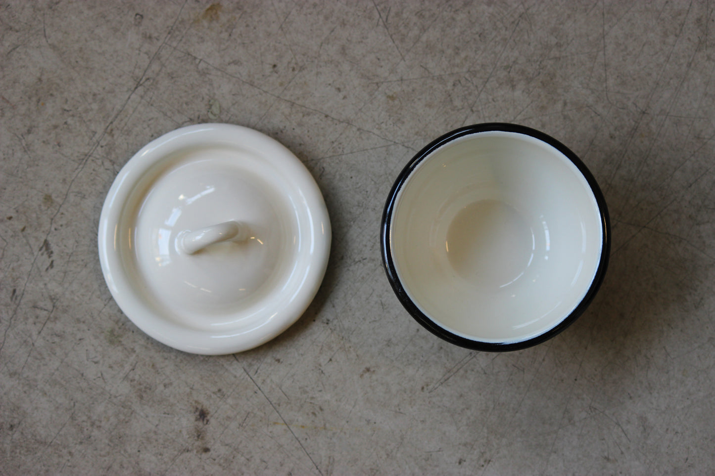 Enamel bowl on a textured surface.