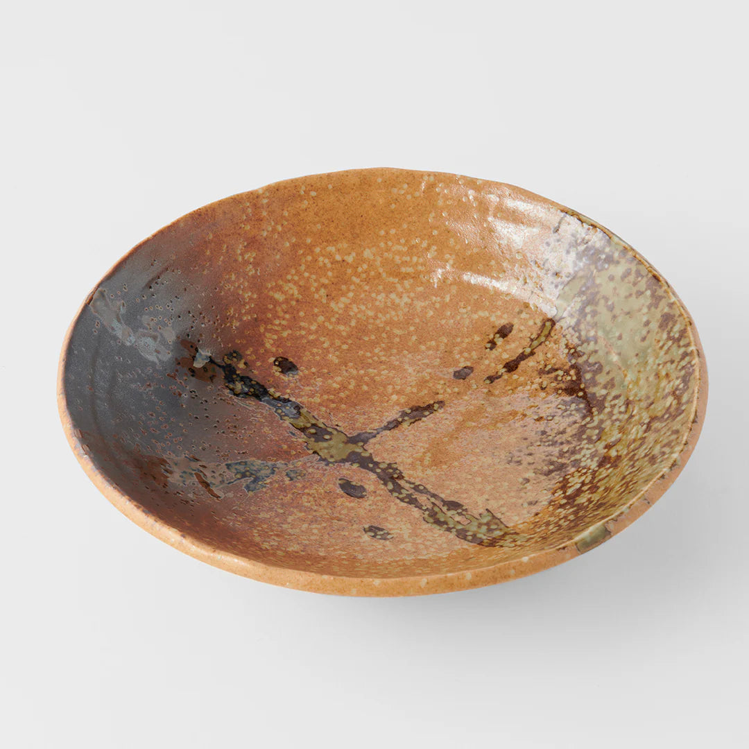 Brown ceramic bowl with speckled pattern on a white background