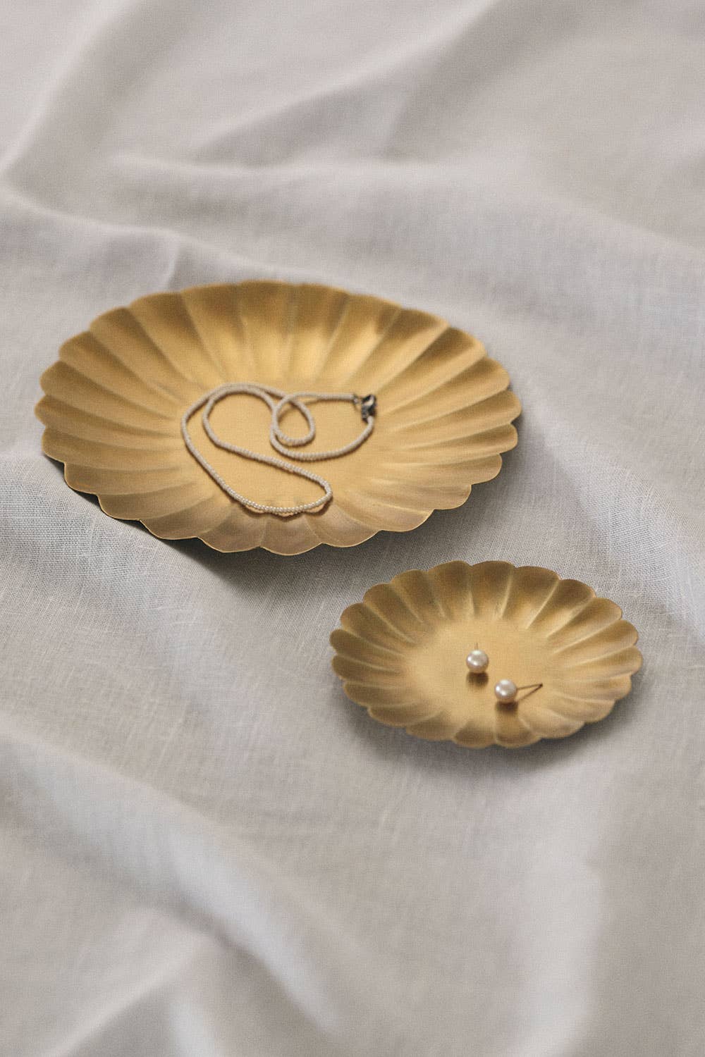 This brass tray features a petal-like wave design around the edges. Perfect for daily use, whether it's holding keys, accessories or serving treats.