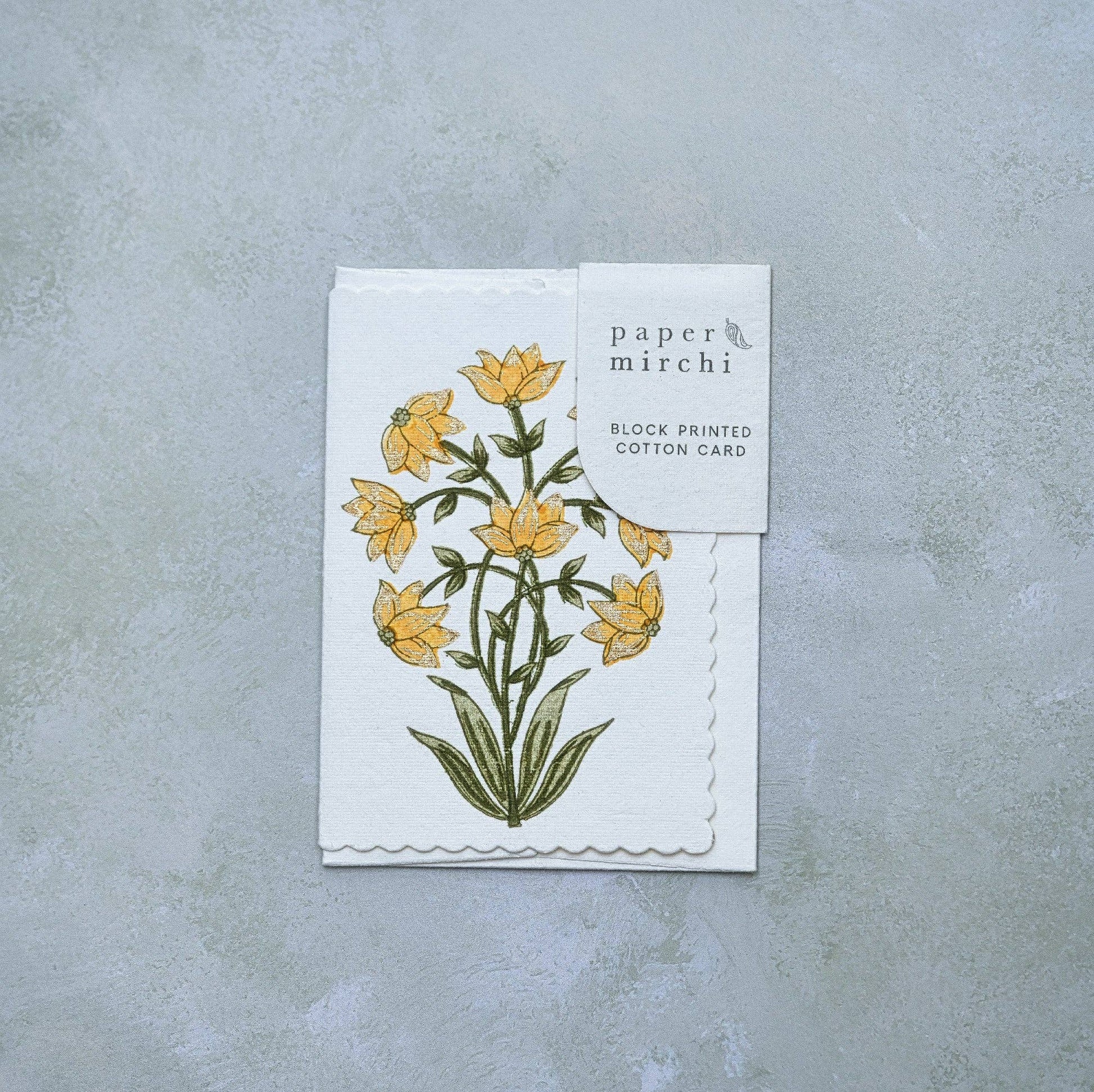 Card with floral design and 'paper mirchi' branding on a gray background