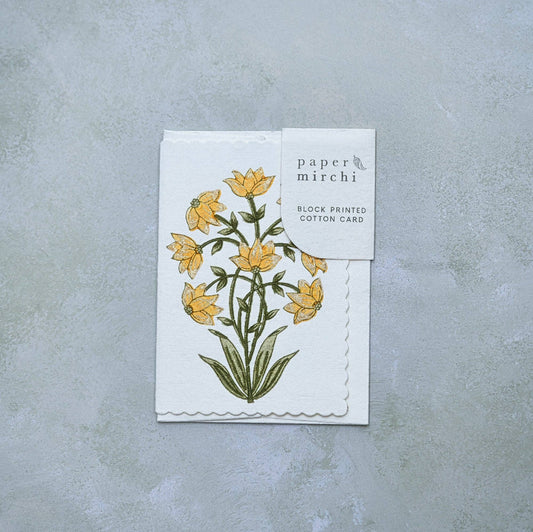 Card with floral design and 'paper mirchi' branding on a gray background