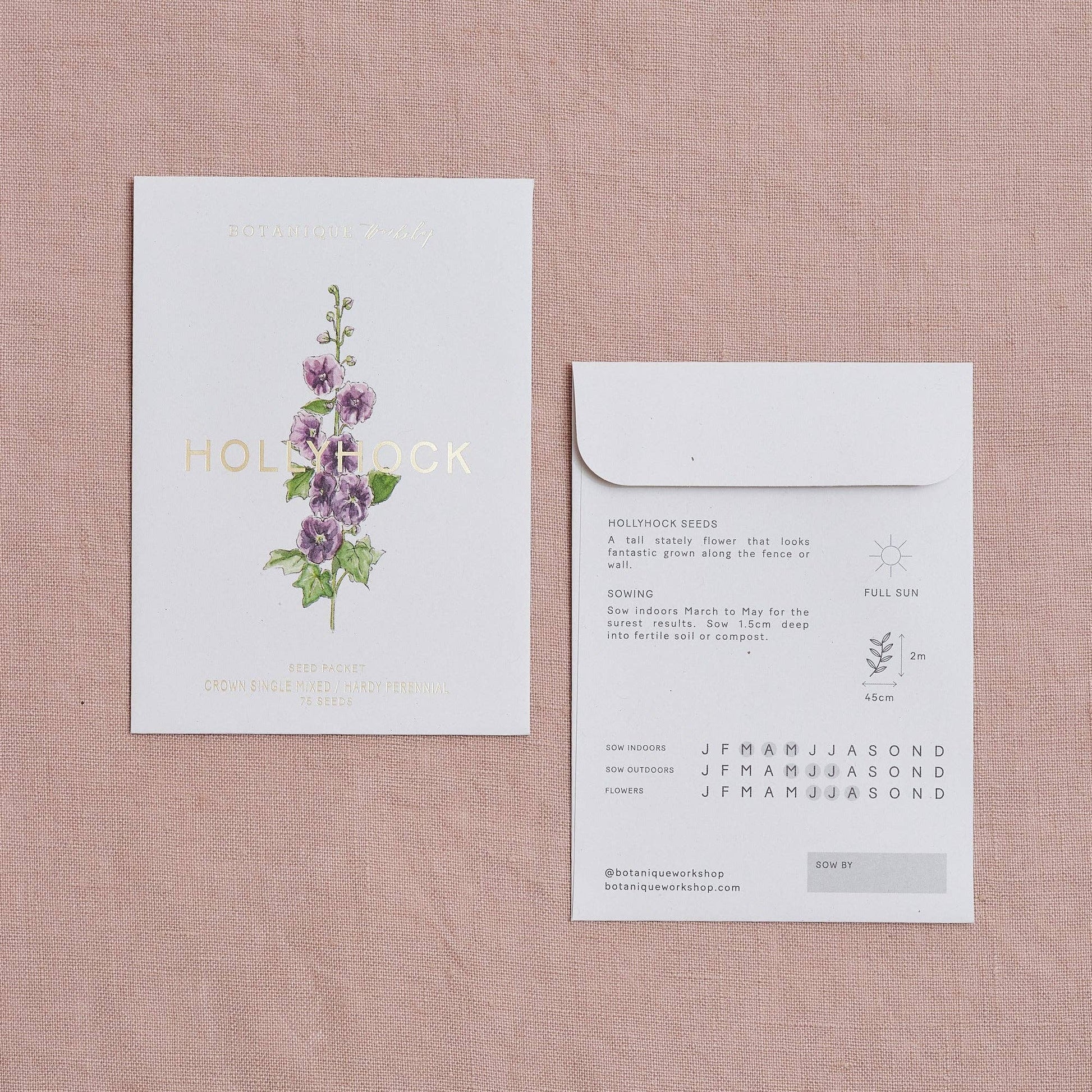 Floral product packaging with a card and envelope on a textured surface