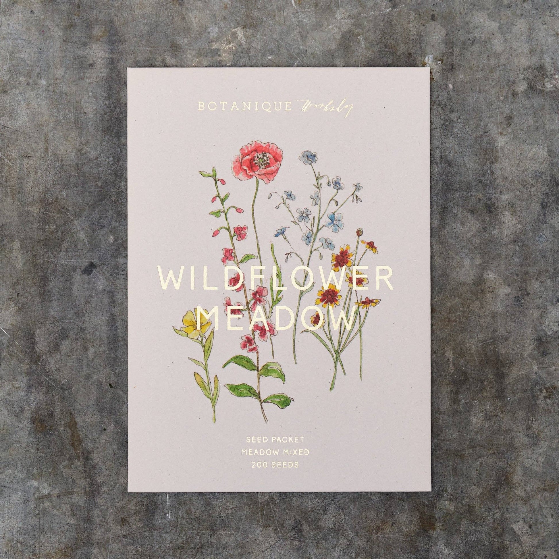 Seed packet with wildflower illustration on a textured surface