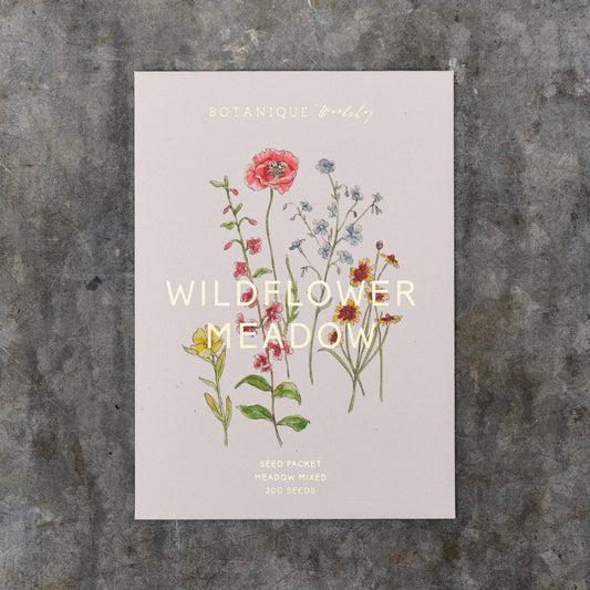 Seed packet with wildflower illustration on a textured surface