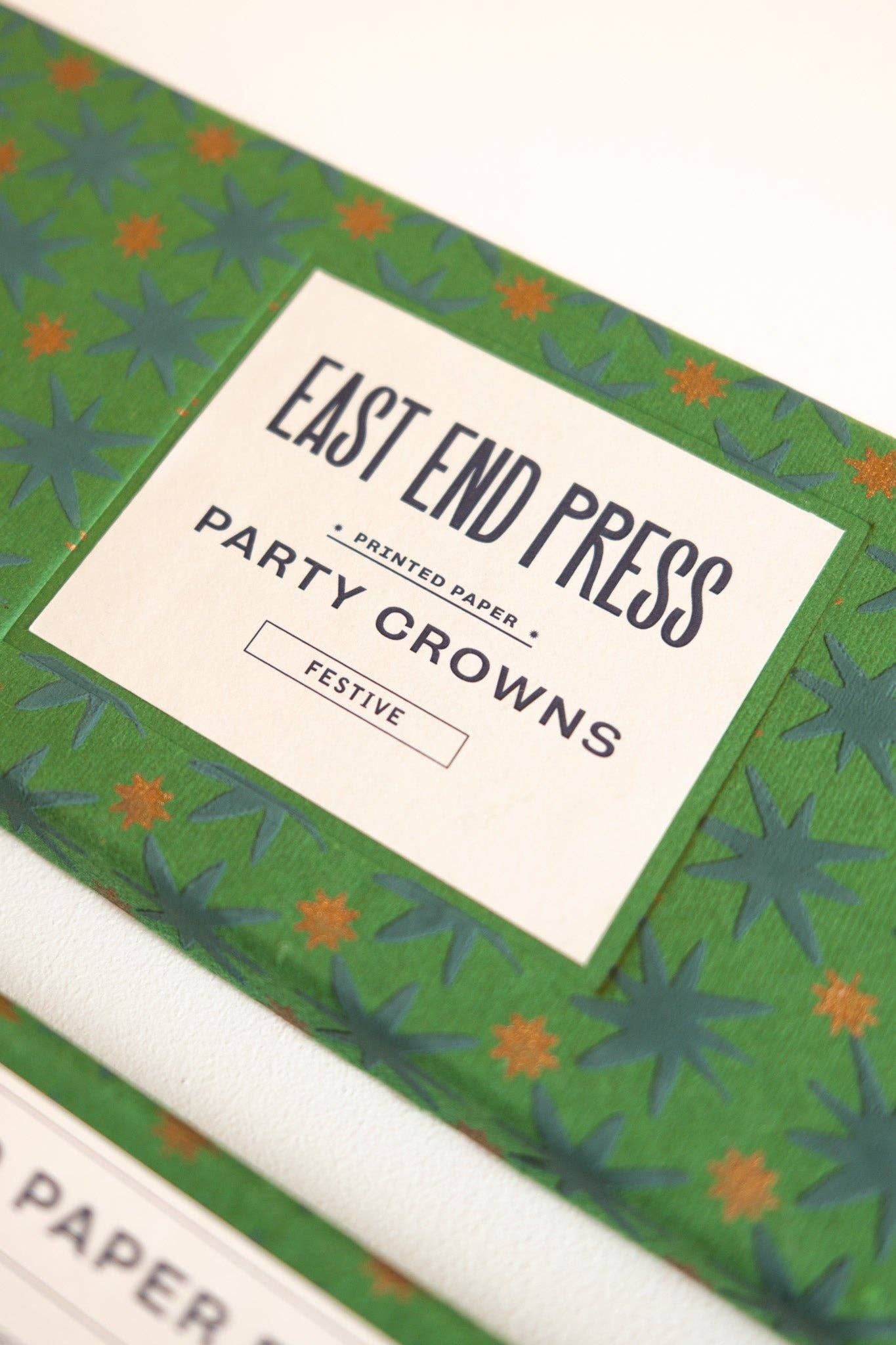 Box of East End Press party crowns with festive design
