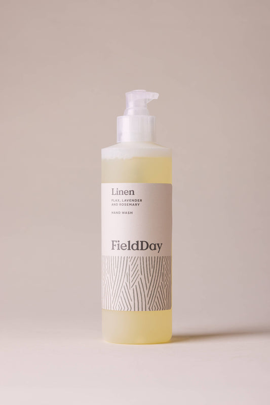 FieldDay linen scented body wash bottle on a beige background
