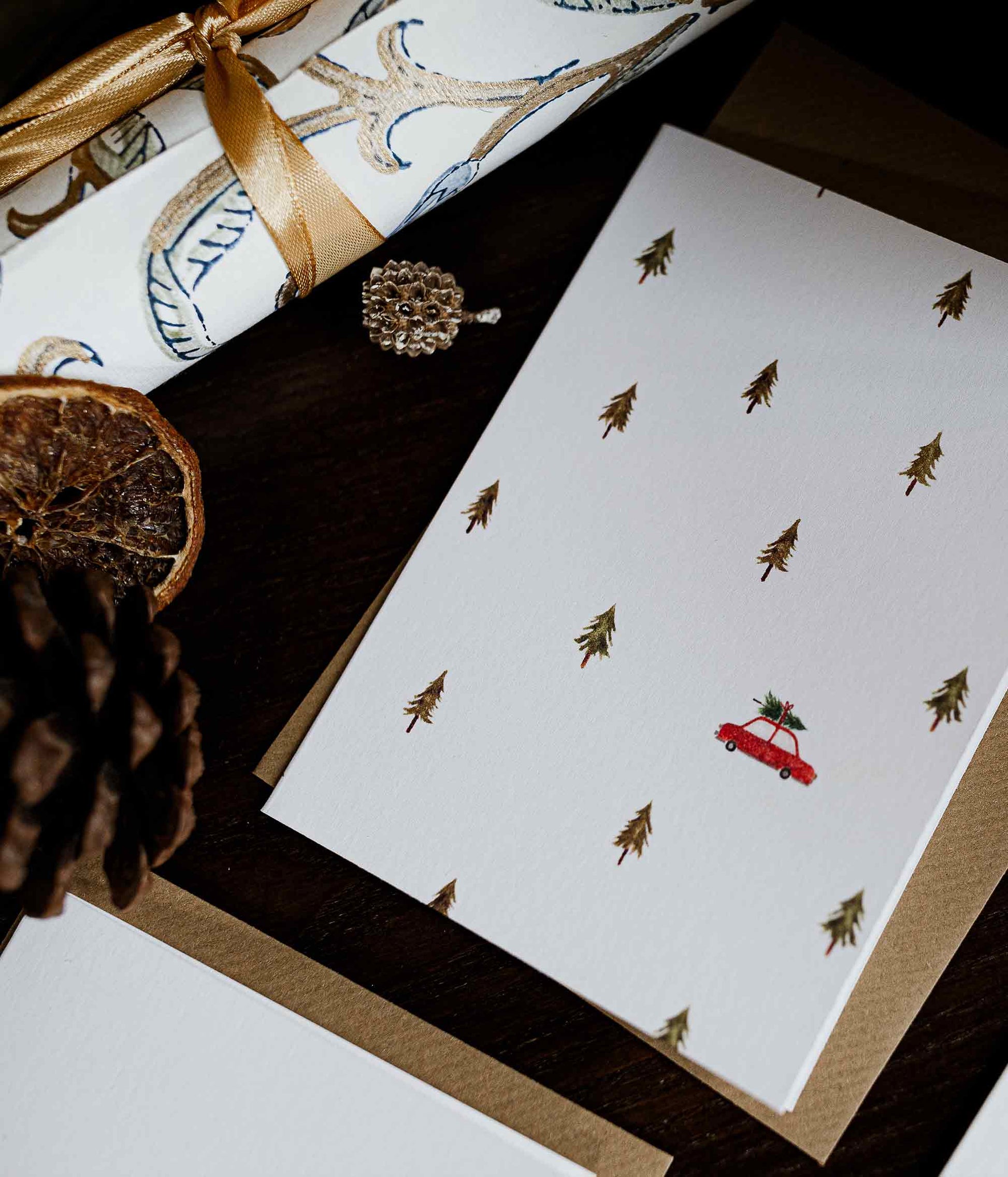 Greeting card with Christmas tree and car design on a dark surface