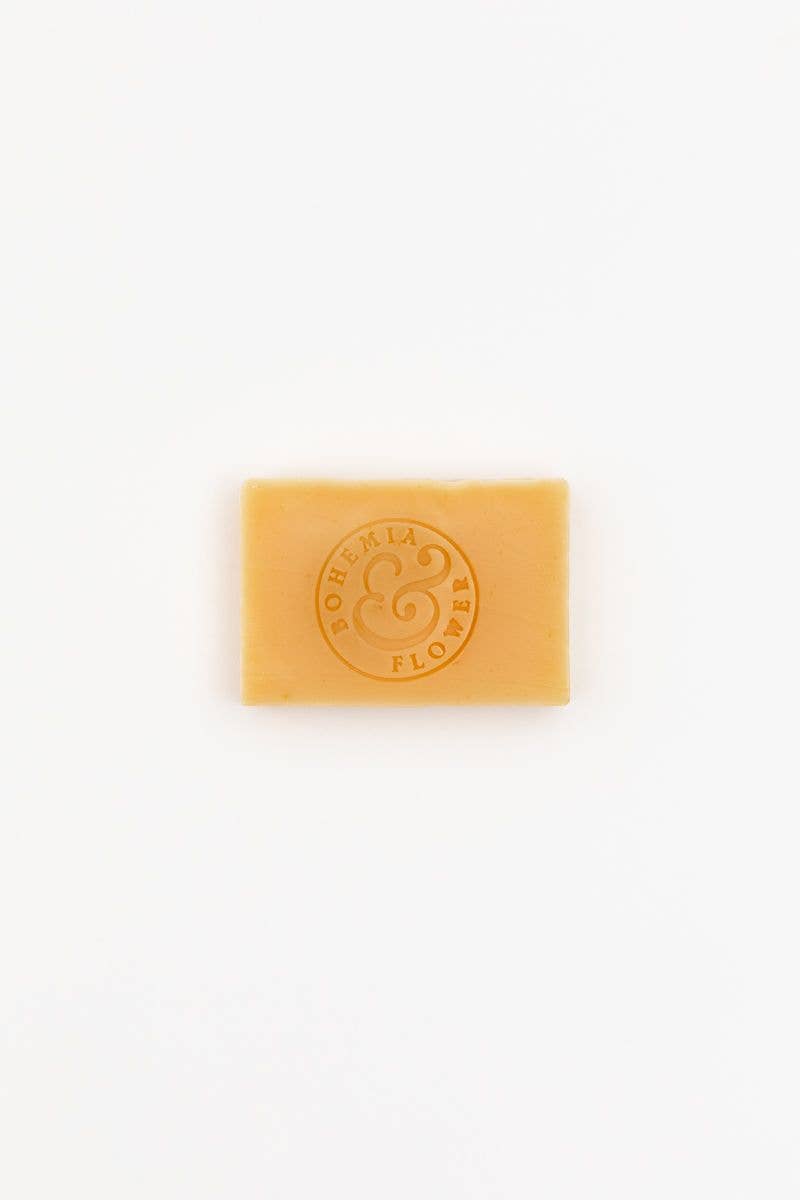 Yellow soap bar with a logo on a white background