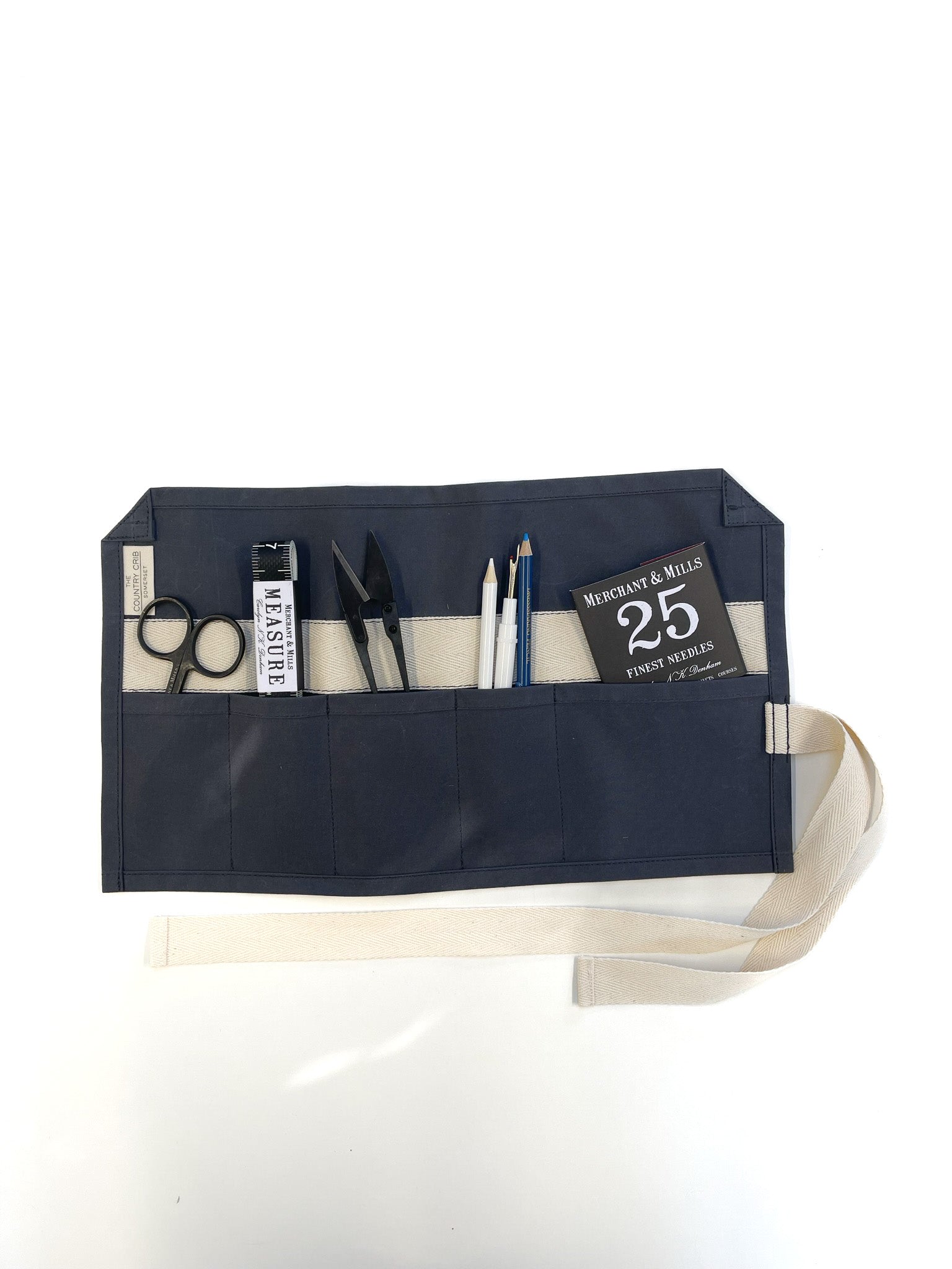 Spruce roll-up sewing roll pouch with tools and a ruler on a white background