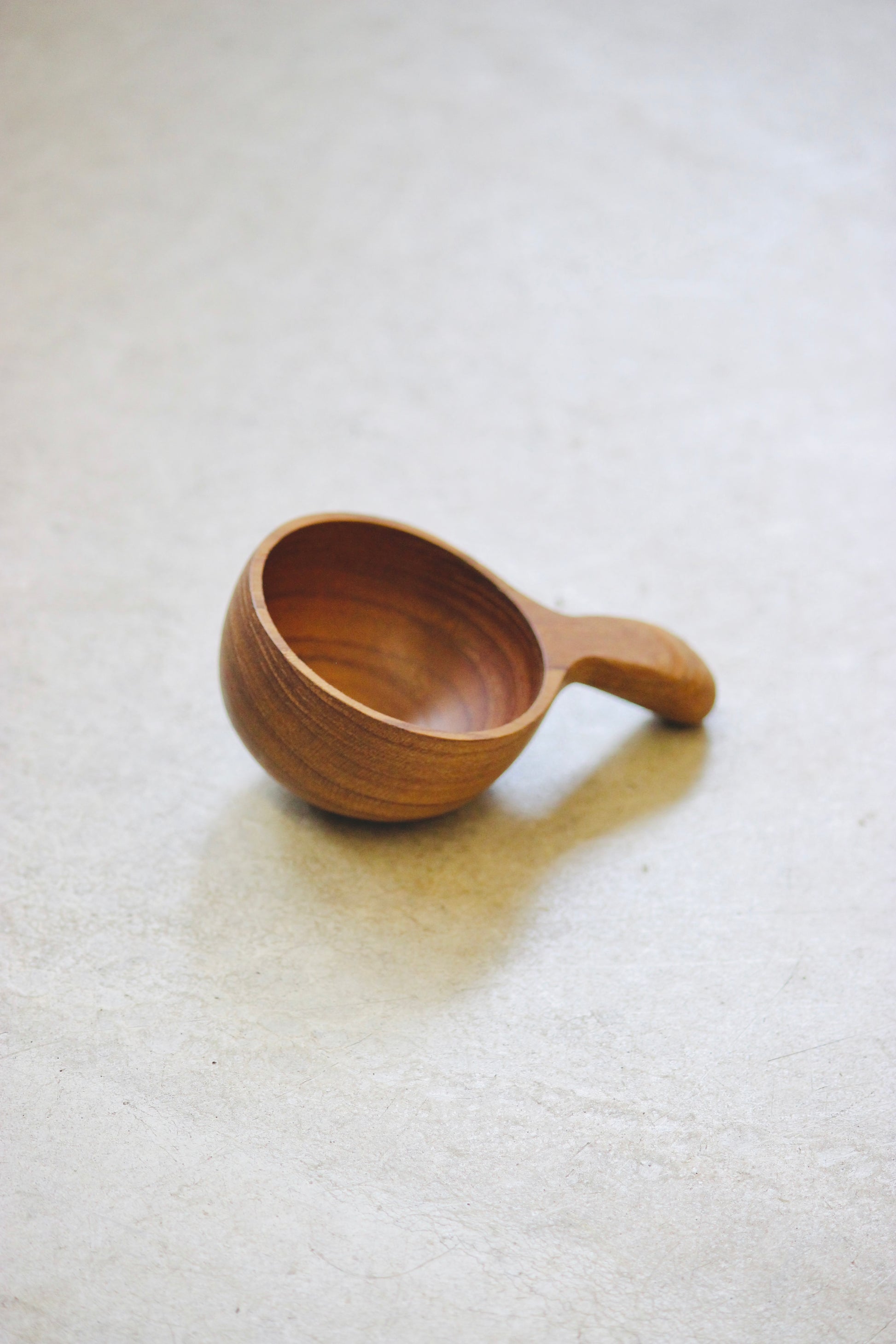 The Amuze Spoon is a versatile tool that can be used to serve appetizers or scoop up coffee and tea. Made from durable and reclaimed teak root wood, each piece boasts a unique, organic design and is food safe.