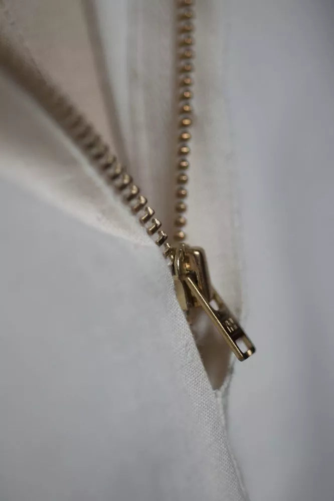 Close-up of a gold zipper on a white background