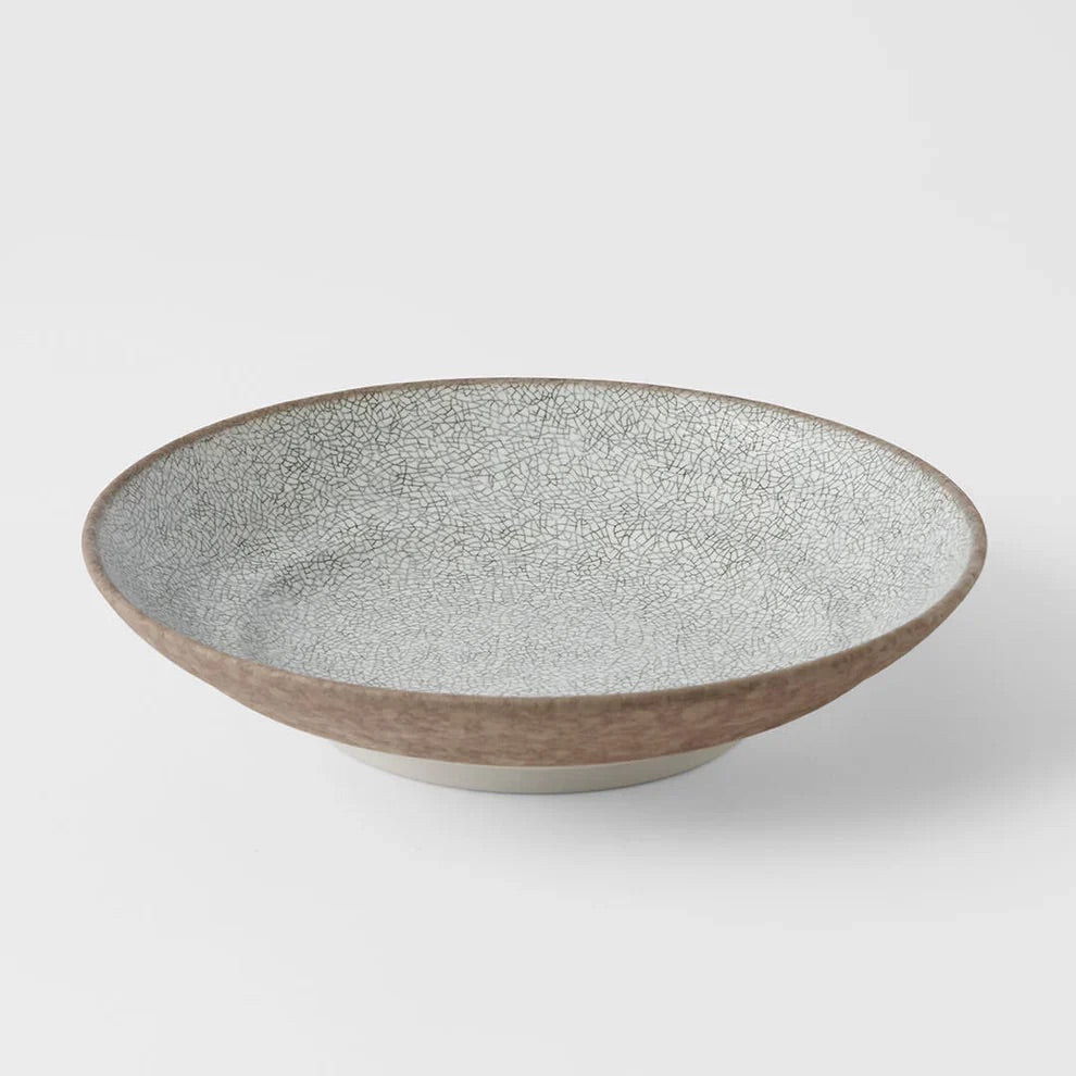 Ceramic bowl with textured surface on a white background. Crazed Grey Shallow Bowl made in Japan 