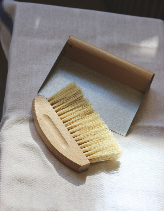 Mini Dustpan Set Cleaning brush and dustpan on a white cloth