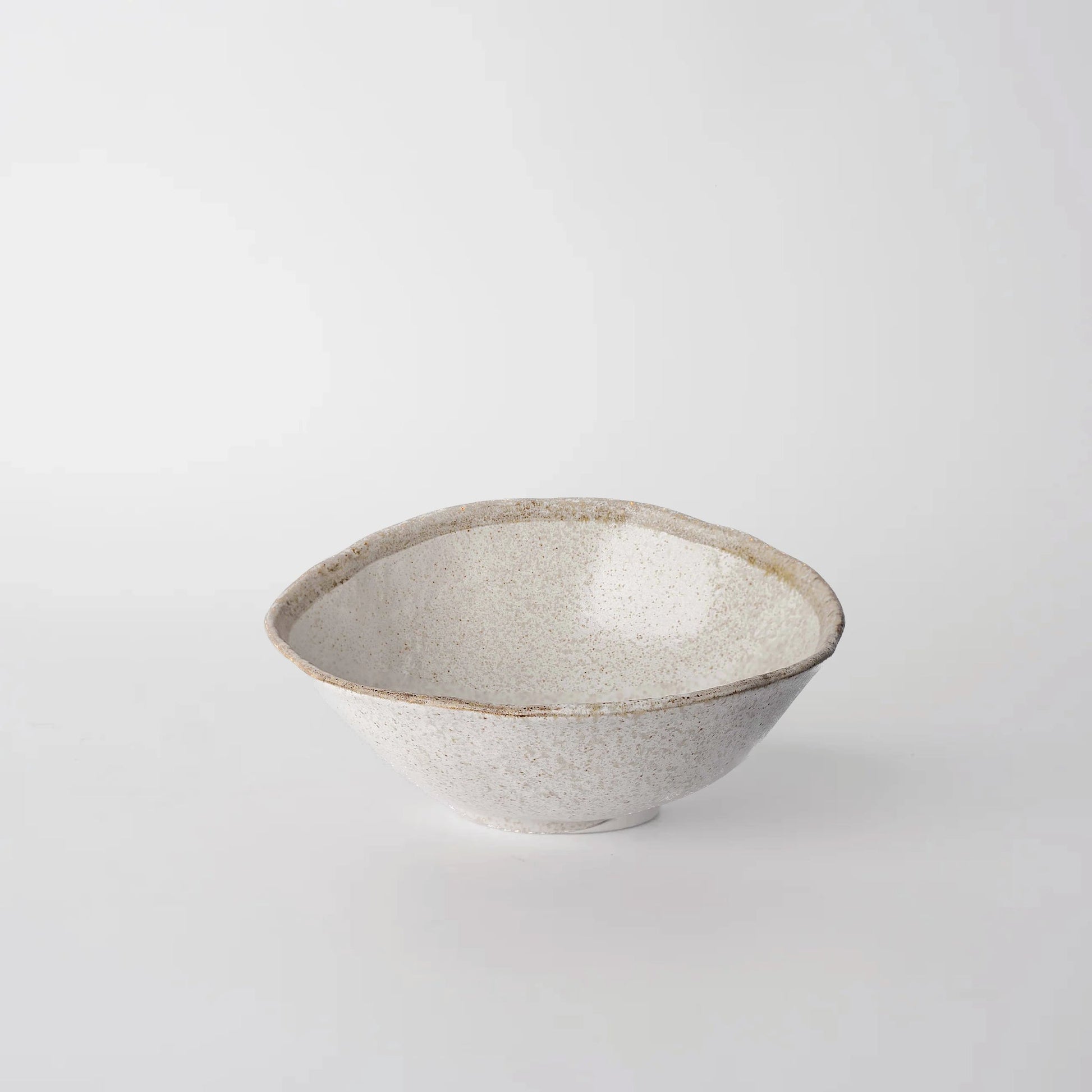 Ceramic bowl with speckled texture on a light gray background