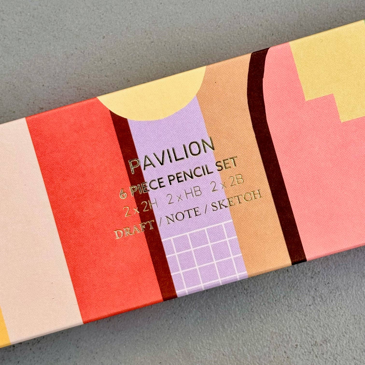 This wonderful 6-piece pencil collection includes 2 square 2H pencils, 2 triangular HB pencils, and 2 hexagonal 2B pencils. Crafted in the UK from sustainably sourced, PEFC-certified wood, each set is presented in a stylish box featuring gold foil accents and a divided tray. Dimensions: 18.5cm x 7cm x 2cm. A perfect gift.