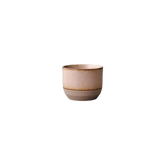 Ceramic cup with two-tone design on a white background