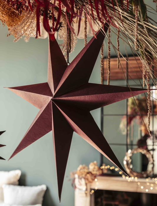 Garden Trading Decorative star hanging on a wall with festive decorations