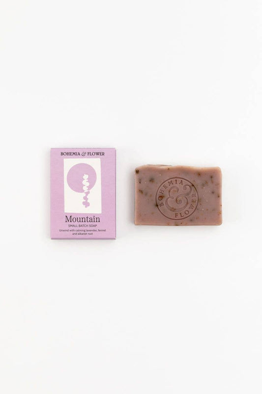 Bar of soap with a pink packaging label on a white background