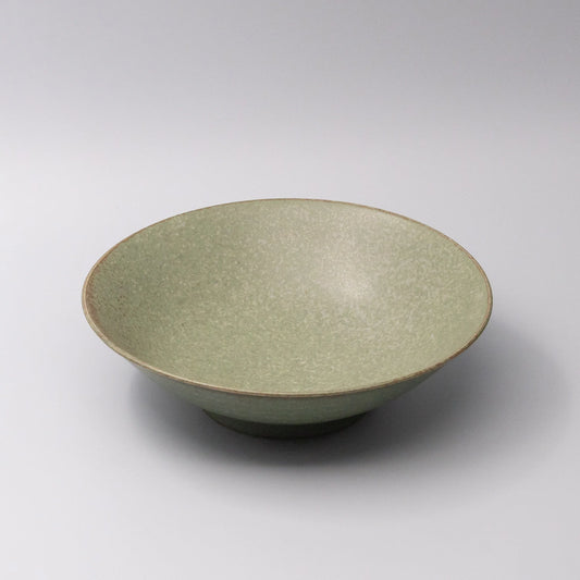 Green ceramic bowl on a white background