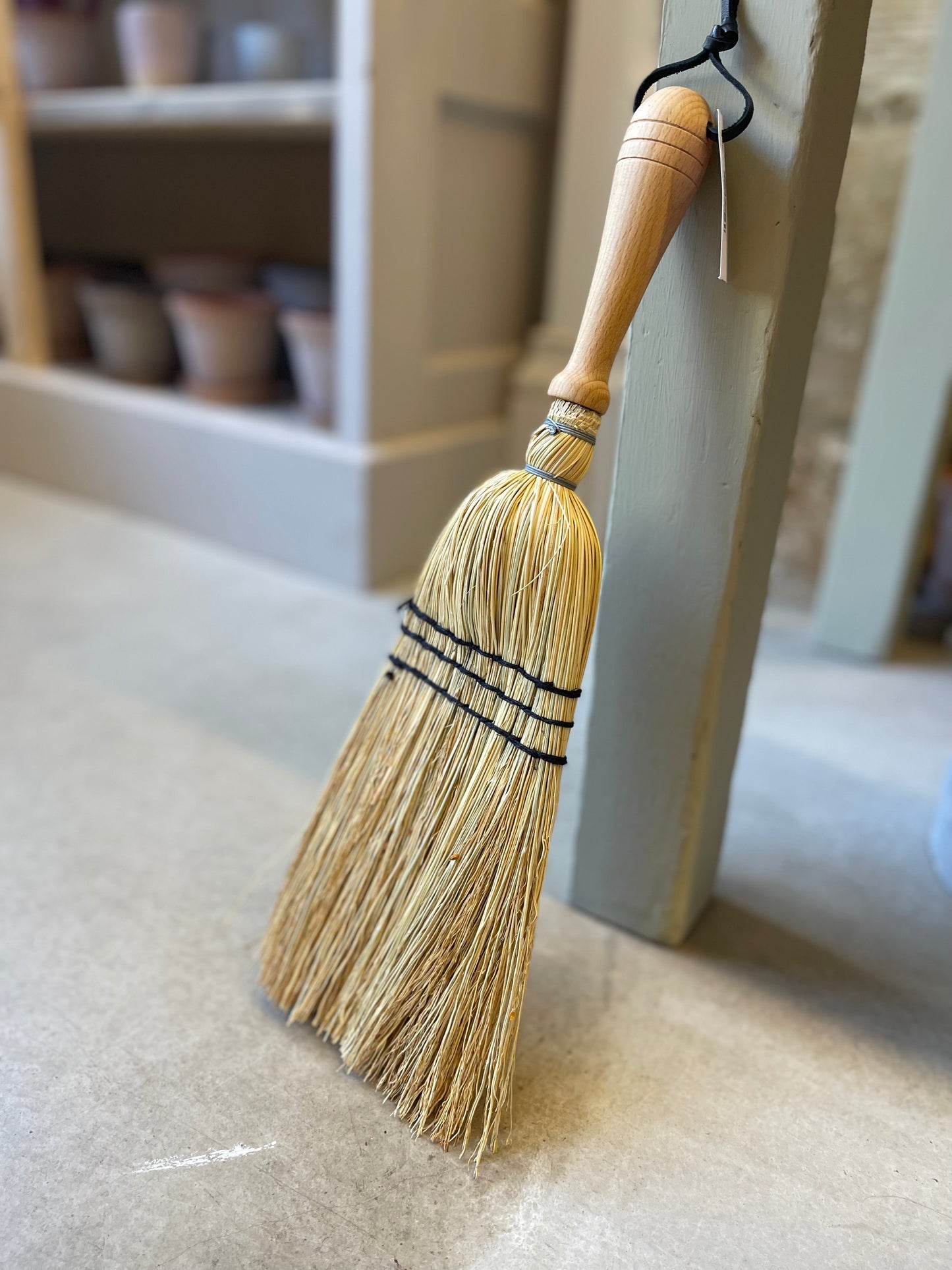 Crafted from oiled beechwood and rice straw, this hand brush is ideal for indoor and outdoor use. Its non-absorbent properties make it perfect for sweeping up car mats and other surfaces. Measuring at 43cm, this is a smaller handheld brush designed in the shape of a broom. Please note that it is not a full-size broom.