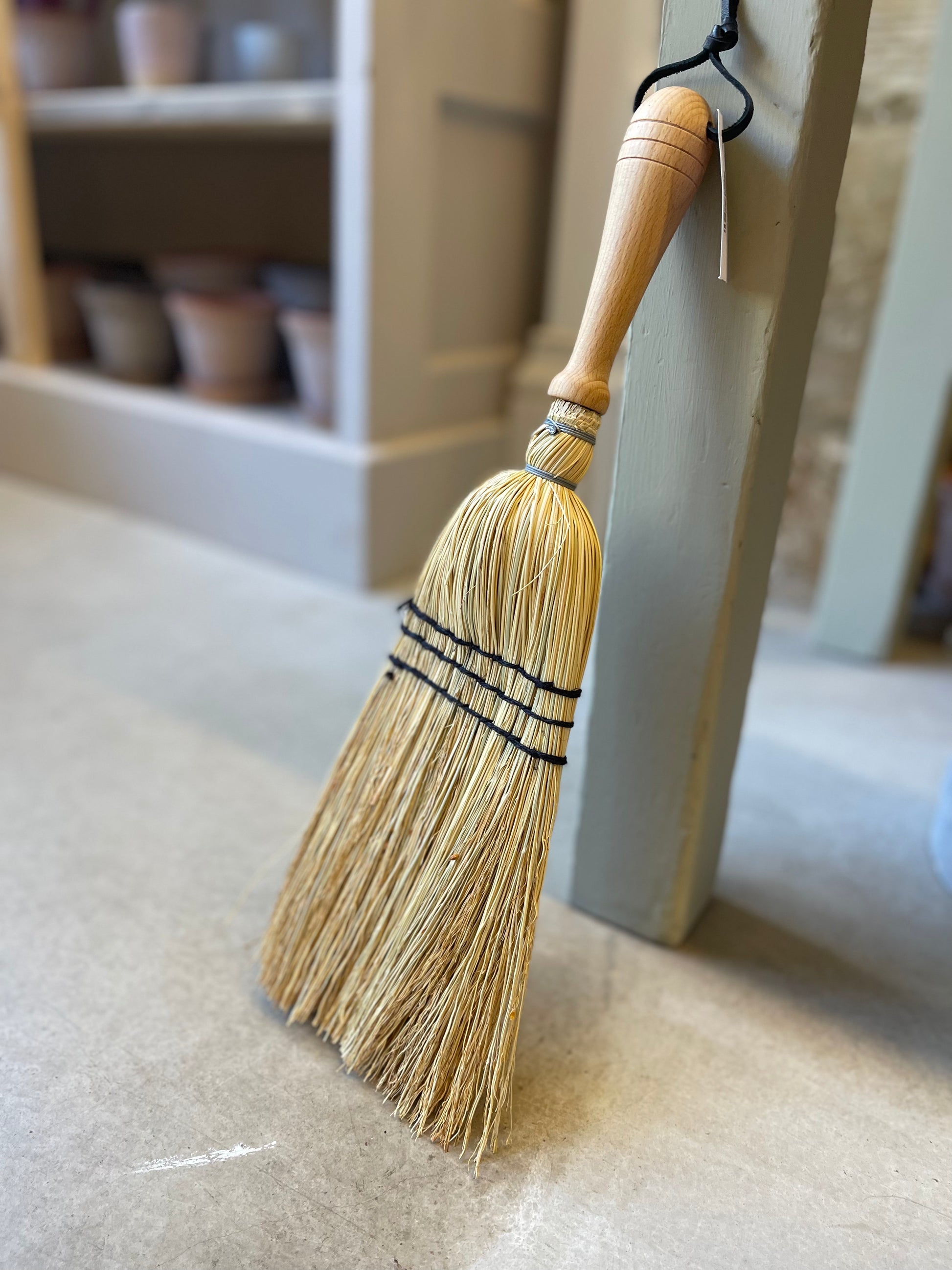 Crafted from oiled beechwood and rice straw, this hand brush is ideal for indoor and outdoor use. Its non-absorbent properties make it perfect for sweeping up car mats and other surfaces. Measuring at 43cm, this is a smaller handheld brush designed in the shape of a broom. Please note that it is not a full-size broom.
