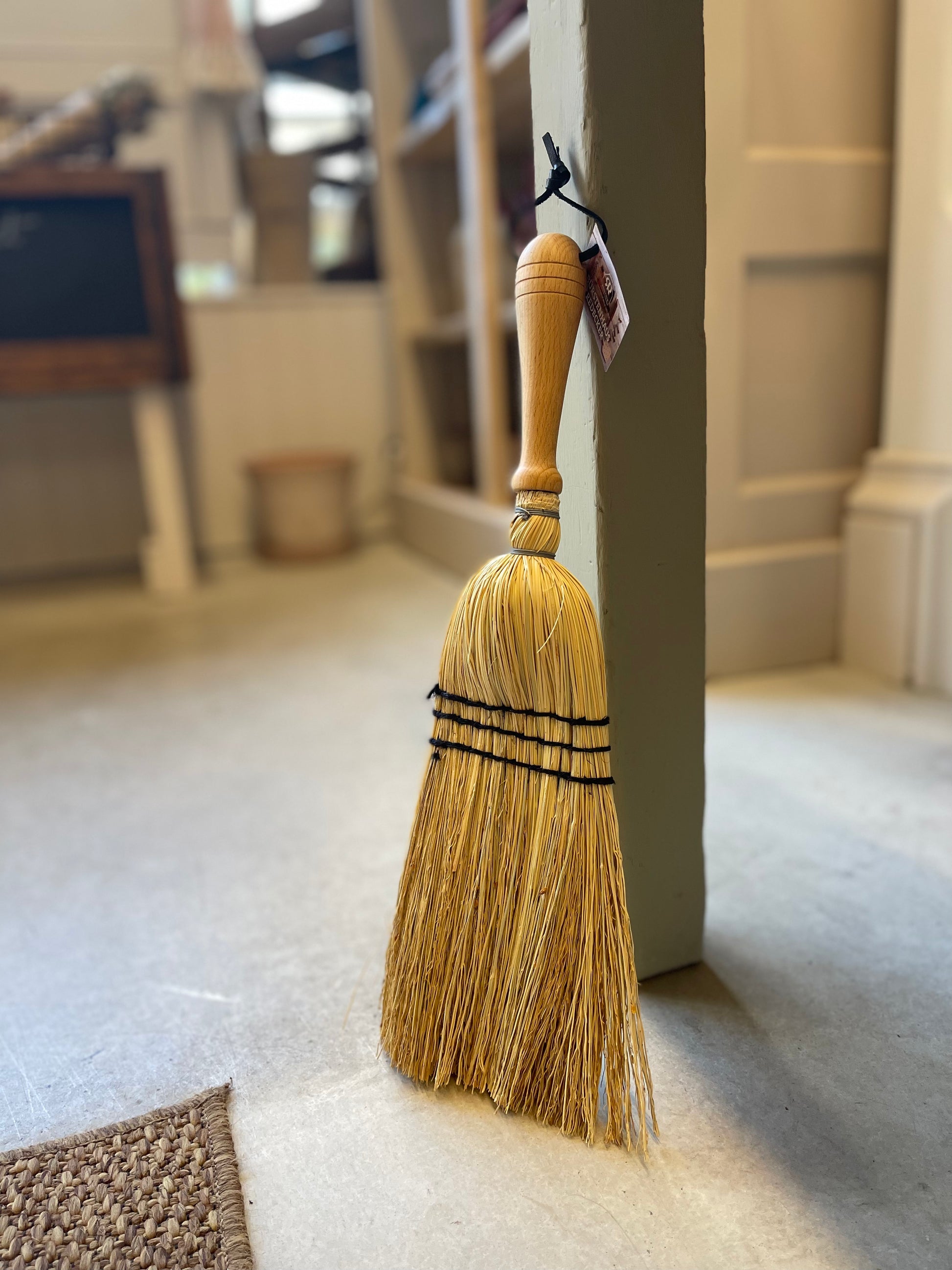 Crafted from oiled beechwood and rice straw, this hand brush is ideal for indoor and outdoor use. Its non-absorbent properties make it perfect for sweeping up car mats and other surfaces. Measuring at 43cm, this is a smaller handheld brush designed in the shape of a broom. Please note that it is not a full-size broom.
