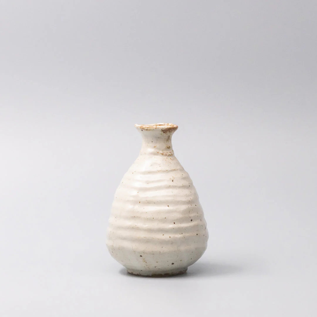 White ceramic sake jug on a light gray background