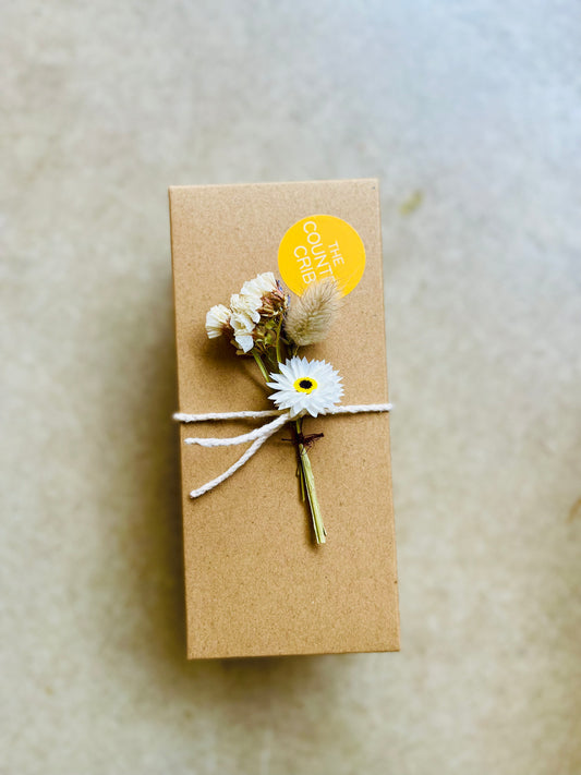 The Country Crib Gift Box, sustainable, no plastic, kraft paper filling and presented with cotton twine and British-grown dried flower spray