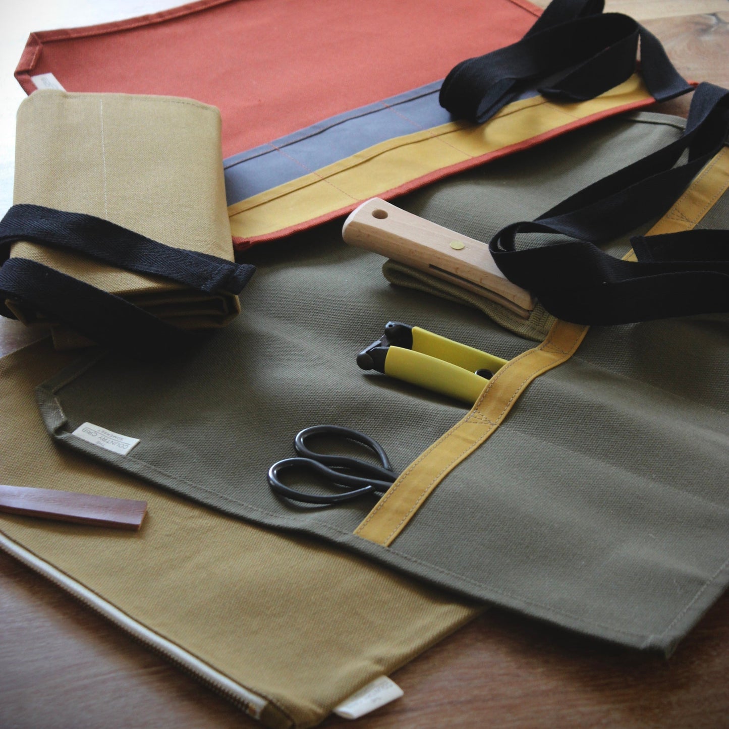 Fabric swatches and sewing tools on a wooden surface