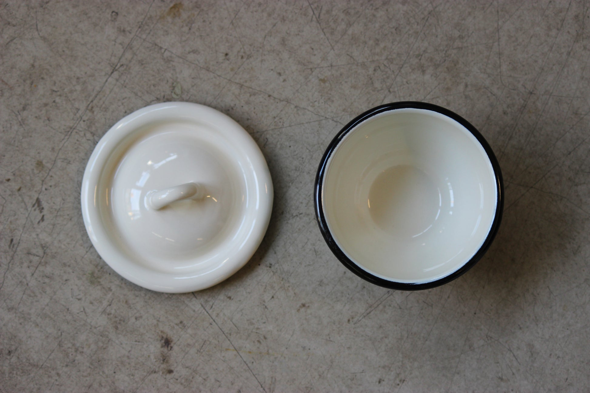 Enamel bowl on a textured surface.