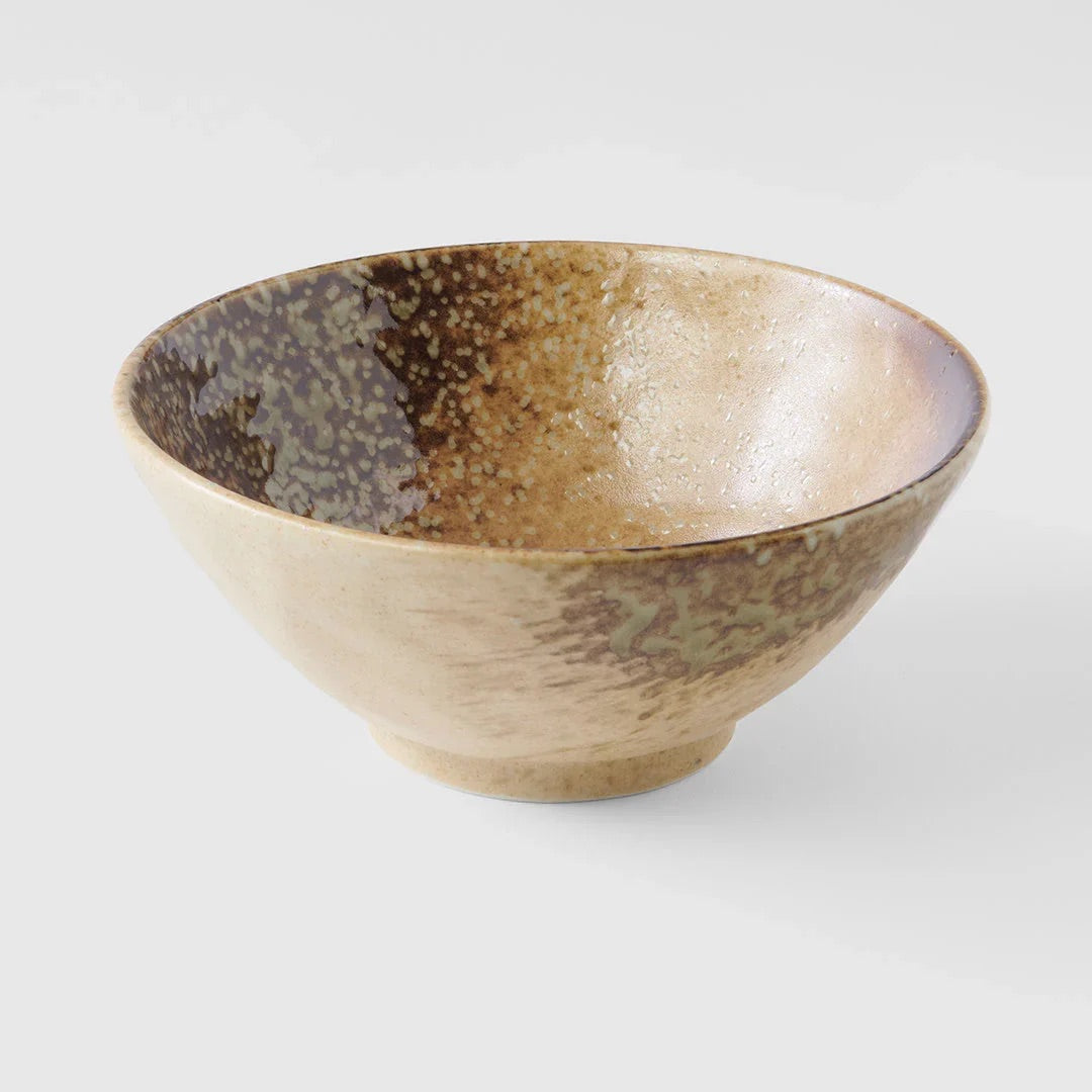 A handmade ceramic bowl with a textured glaze, featuring a speckled brown and beige pattern on the interior and exterior, set against a plain light gray background. Wabi Sabi Udon Bowl 19cm made in Japan 
