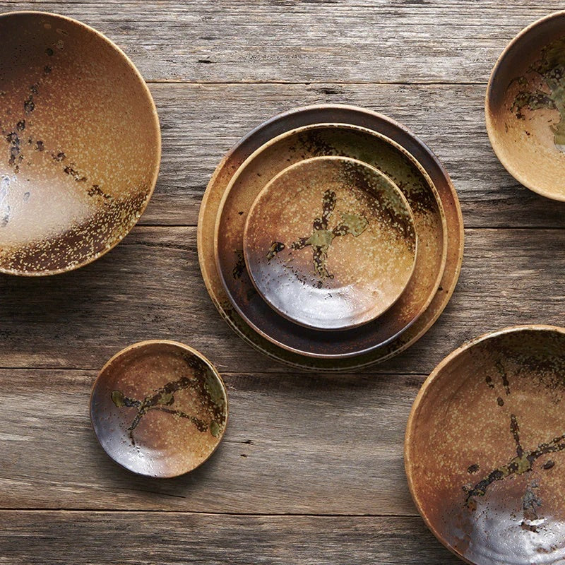 Range of of Wabi Sabi Jpanese made ceramic plates with rustic brown glaze on a wooden surface. Made in Japan, brought to you by The Country Crib.