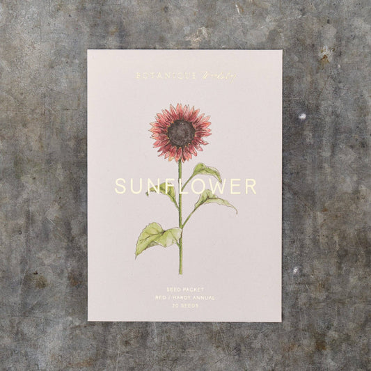 Seed packet of a sunflower illustration on a textured surface