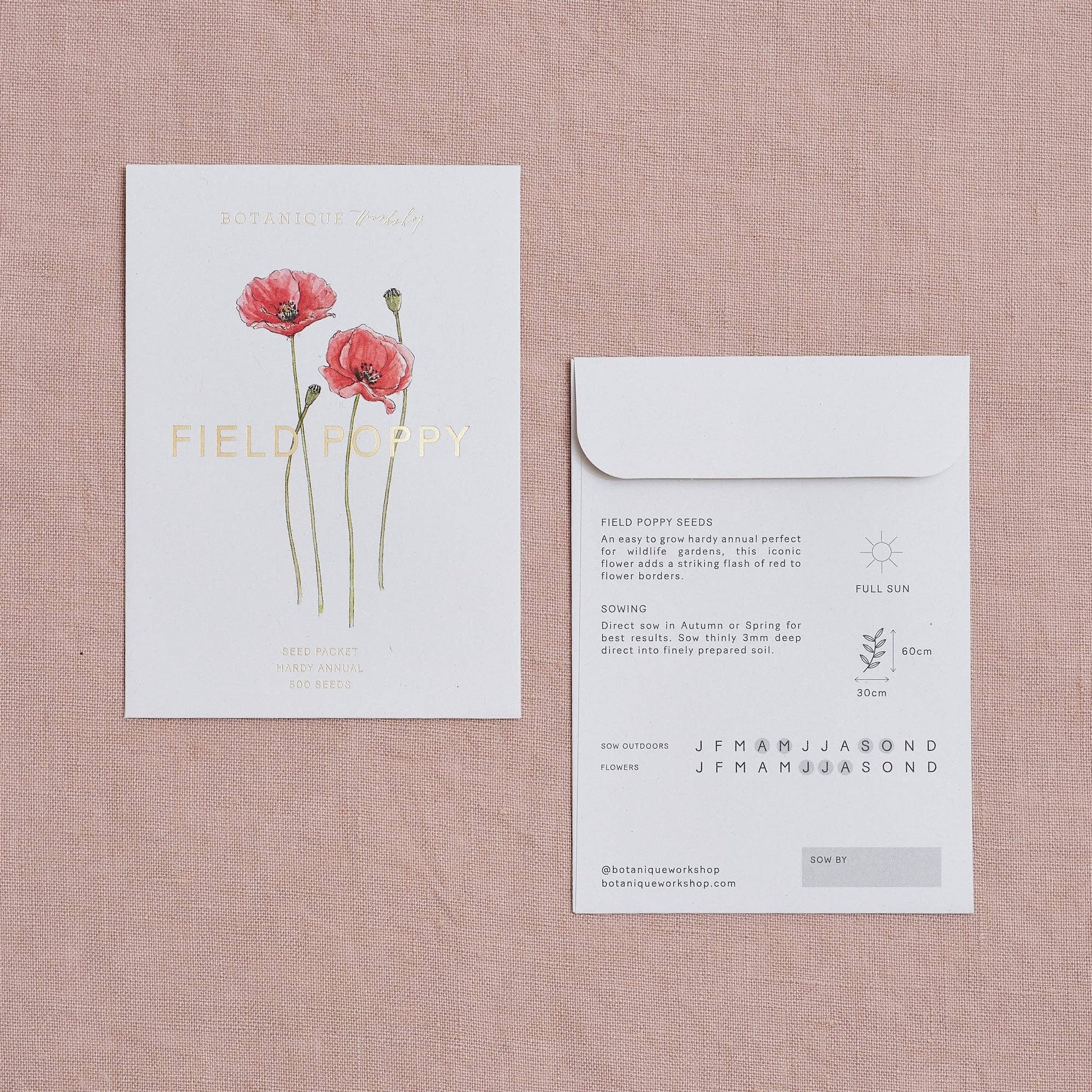 Seed packet card with floral design and envelope on a textured pink surface