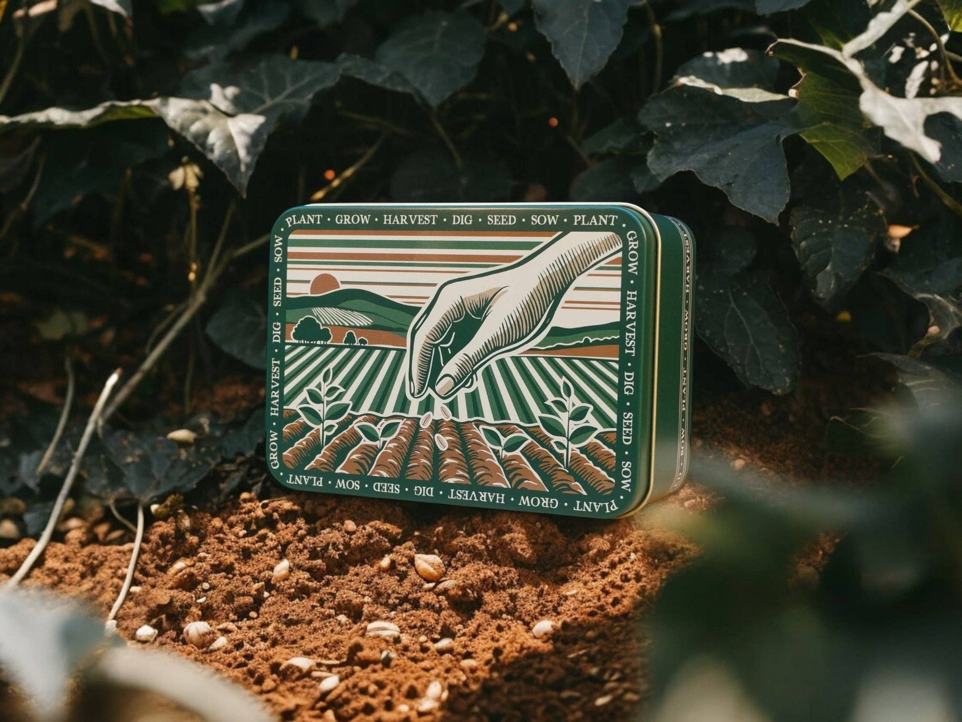 Decorative tin with agricultural design on a bed of soil and leaves