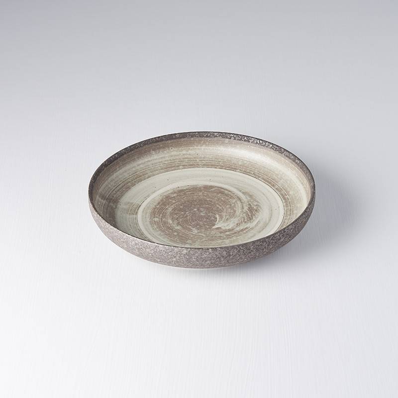 Ceramic bowl with earthy tones on a light gray background