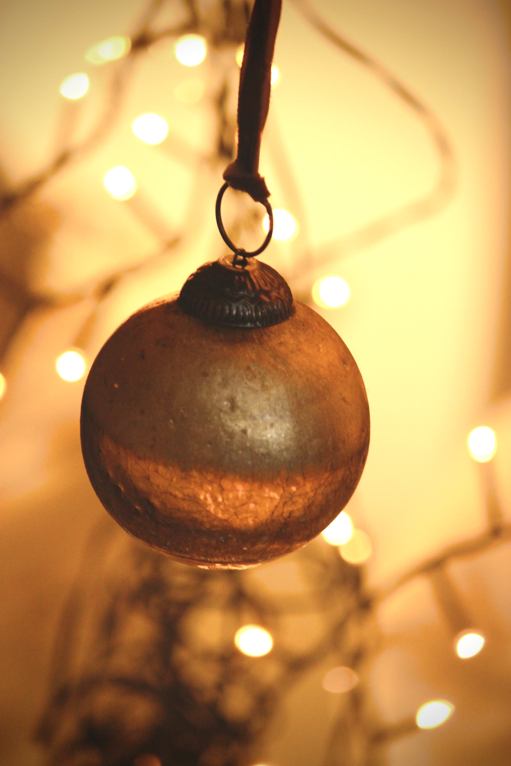 Decorative ornament hanging against a warm, blurred light background