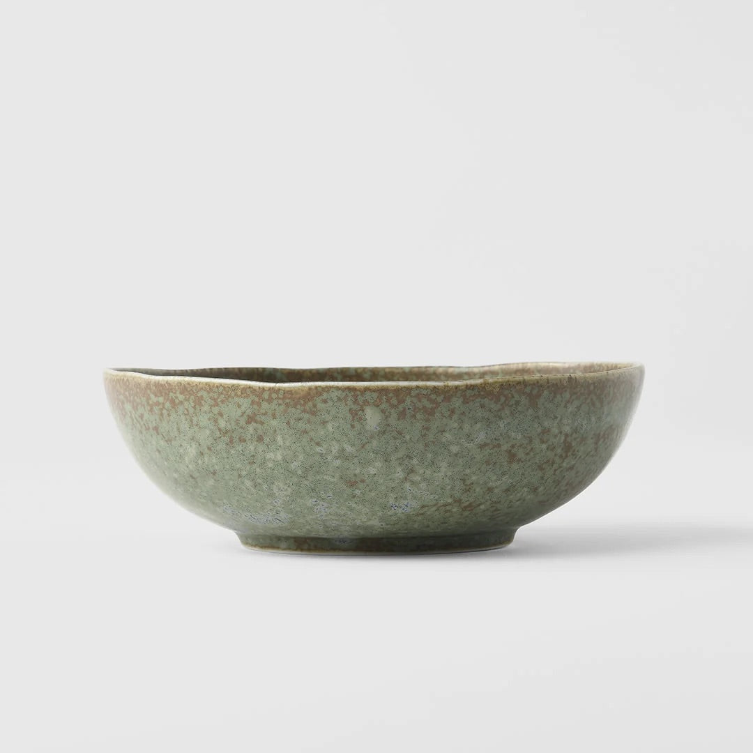 Green ceramic bowl on a light gray background. Green fade bowl from Japan 